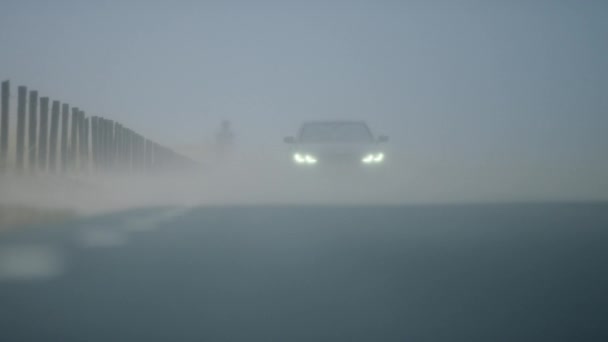 Stationary Footage Silhouette Car Visible Headlights Driving Way Foggy Road — Stock video