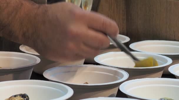 Close Gimbal Shot Hand Serving Pumpkin Sauce Cardboard Tasting Cups — Stok video