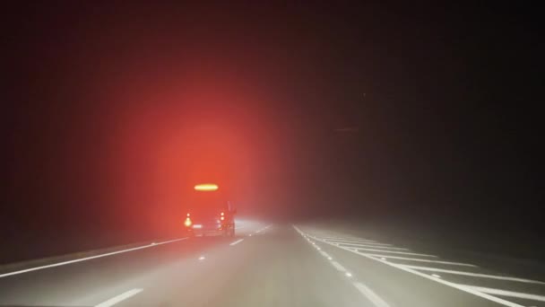 Ambulance Flashing Red Lights Speeding Misty Road Night — стоковое видео