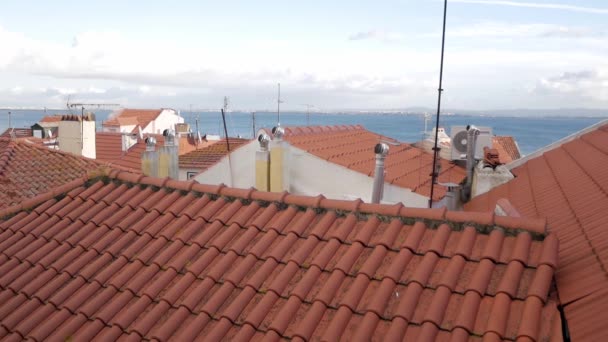 葡萄牙里斯本的全景地平线 Alfama街区的房子 屋顶有黏土瓦 烟囱有旋转的牛仔 老教区 Freguesias 在首都 Tagus河多云的天空 — 图库视频影像