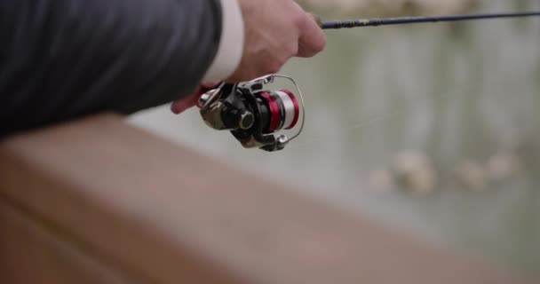 Close Fisherman Hands Reeling His Fishing Rod Lakeside Fishing — Wideo stockowe