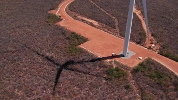 Rotating Wind Turbine Shadow Aerial Tilt Revealing Field Wind Turbines — Video