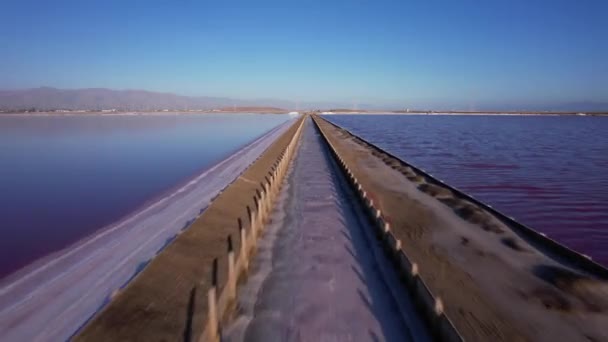 Straight Low Altitude Flight Water Channel Maroon Colored Salt Ponds — Stock Video