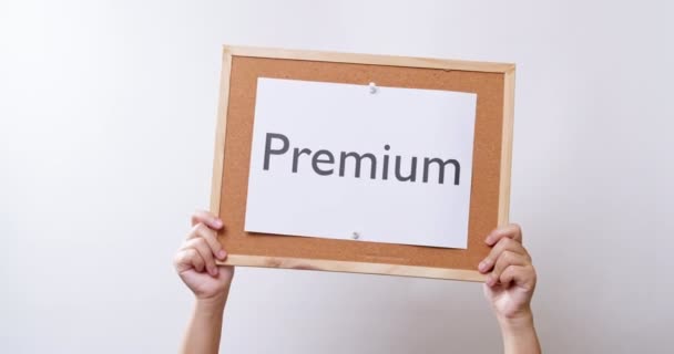 Woman Hand Shows Paper Board Word Premium White Studio Background — Vídeos de Stock