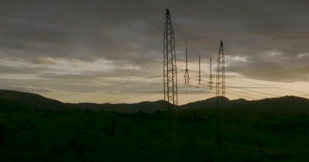 Aerial Circling Silhouette Overhead Powerline Dramatic Sunset — Vídeo de Stock
