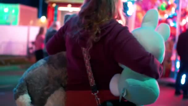 Lady Looking Fairground Octopus Holding Huge Stuffed Animals — Video