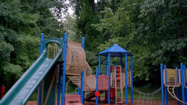 Empty Playground Lush Green Forest Rainy Day — Stockvideo