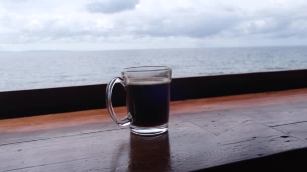 Freshly Brewed Black Coffee Mug Calm Seascape Background Close — Vídeo de Stock