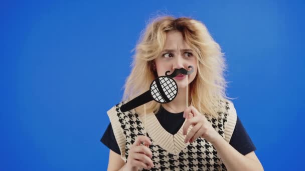 Young Woman Pretending Man Fake Mustache Paper Microphone Isolated Blue — Video