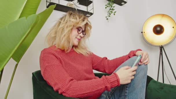 Happy Blond Woman Browsing Social Media While Relaxing Armchair Slow — Stok video