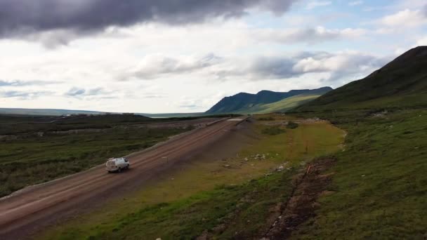 Aerial Follow Van Traveling Dirt Road Mountains Crossing Bridge River — Stockvideo