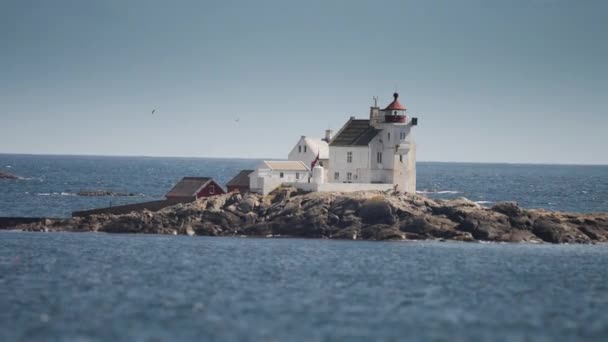 Solitary Lighthouse Tiny Rocky Island Pan Follow — стоковое видео