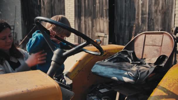 Boy Old Yellow Tractor Pretending Driving Turns Steering Wheel Woman — Vídeo de Stock