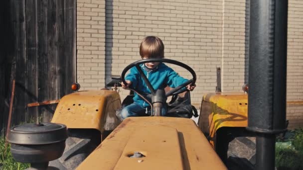 Boy Old Yellow Tracto Pretending Driving Turns Steering Wheel Playing — стоковое видео