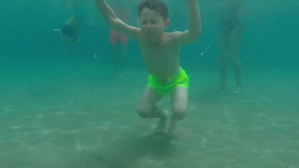 Young Boy Having Fun Turquoise Beach Water Camera Follow Him — Stockvideo