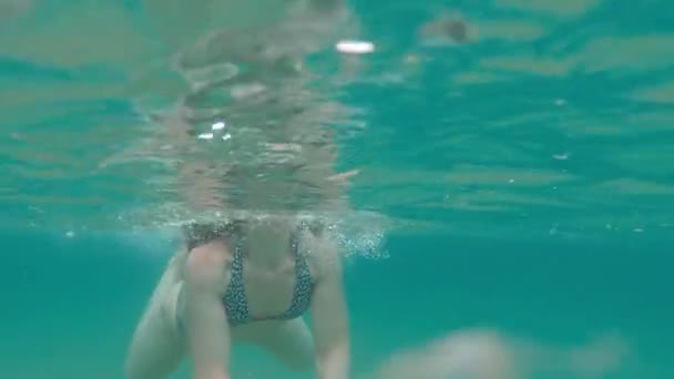 Caucasian Female Swims Translucent Water Split Shot Underwater Sea Surface — Stockvideo