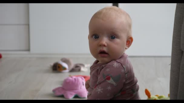 Attentive Baby Girl Looking Straight Camera Slow Motion — Vídeos de Stock