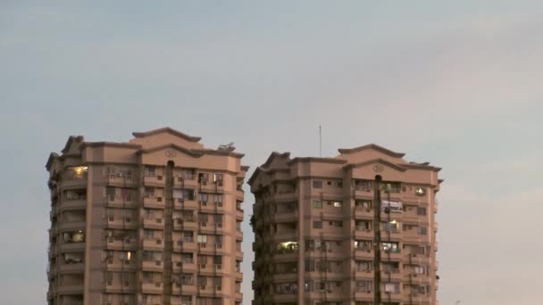 Airplane Flying Sky Twin Residential Towers Sunset Low Angle Wide — Stockvideo