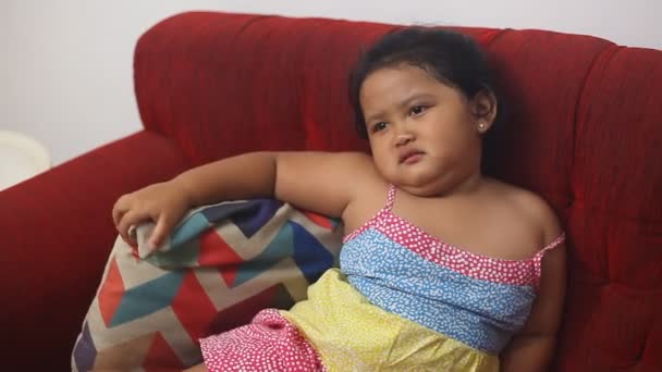 Cute Asian Little Girl Sulking While Siiting Sofa Home — Αρχείο Βίντεο