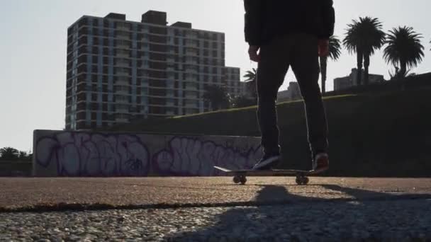 Millennial Practicing Ollie Trick His Skateboard Sunset Closeup Feet — 图库视频影像