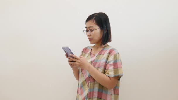 Sad Asian Woman Standing White Wall Home While Hold Cellphone — Stock video