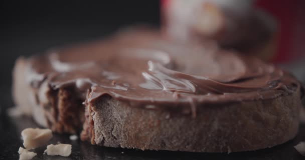 Chopped Hazelnuts Falling Slice Bread Chocolate Cream Pastry Close Shot — Stock Video