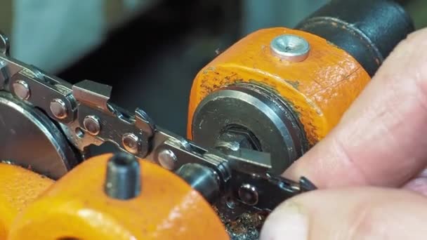 Macro Closeup Operator Using Special Riveting Machine Fix Chainsaw Chain — Stockvideo