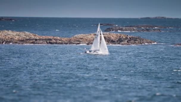 Small Sailboat Battling Waves Rocky Islands Slow Motion Pan Follow — Stockvideo