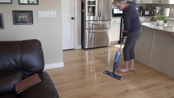 Senior Woman Spray Mopping Hardwood Floor Her Kitchen — Vídeo de Stock