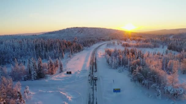 Aerial View Vehicle Joining Snowy Remote Road Heading Woodland Mountain — ストック動画