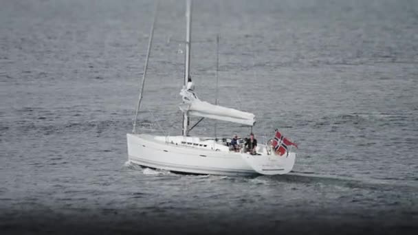 Sailboat Folded Sail Norwegian Flag Goes Motor Slow Motion Pan — Stockvideo