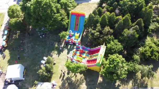 Slow Spinning Aerial Orbit Colorful Bouncy House Festival Bulgaria Dramatic — Vídeo de Stock