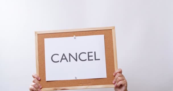Woman Hand Shows Paper Board Word Cancel White Studio Background — стокове відео