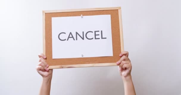 Woman Hand Shows Paper Board Word Cancel White Studio Background — Video