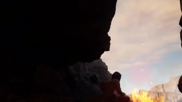 Wide Shot Ancient Hominid Neanderthal Homo Sapiens Sitting Fire Cave — Stock Video