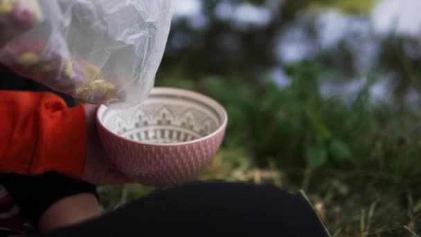 Person Filling Cereal Bowl Have Breakfast Camping Trip Nearby Lake — Stock video