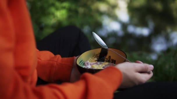 Person Eating Bowl Colorful Cereal Breakfast Camping Trip While Sitting — Stockvideo