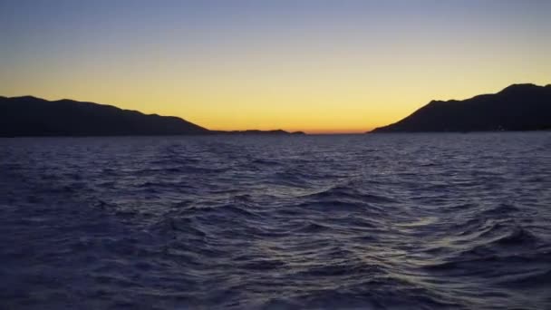 Ocean Waves Silhouetted Mountains Background Sunset Pov — Stock video