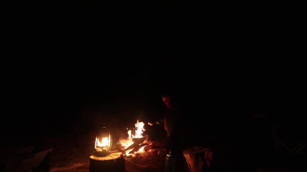 Man Sits Fire Night Australian Bush Lantern Next Him — 图库视频影像