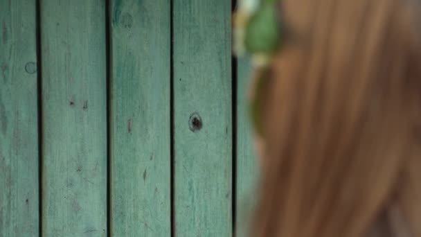 Brunette Female Knocking Old Green Rural Wooden Doors Back View — Stockvideo