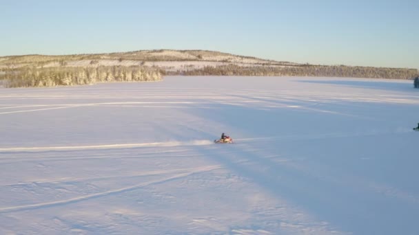 Aerial View Tracking Three Snowmobiles Riding Snowy Lapland Nordic Wilderness — Vídeos de Stock