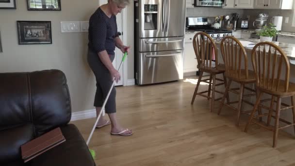 Senior Woman Dusts Sweeps Her Kitchen Floors Tilt — Video Stock