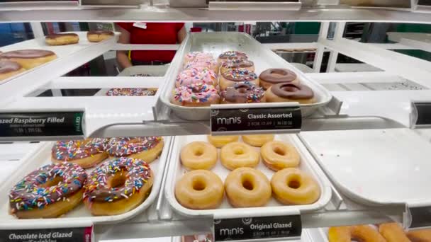 Delectable Tempting Krispy Kreme Doughnuts Sale Display Case Store — Stock video