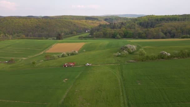 Drone Footage Tractor Driving Away Huge Green Meadow Spraying Its — Vídeo de Stock
