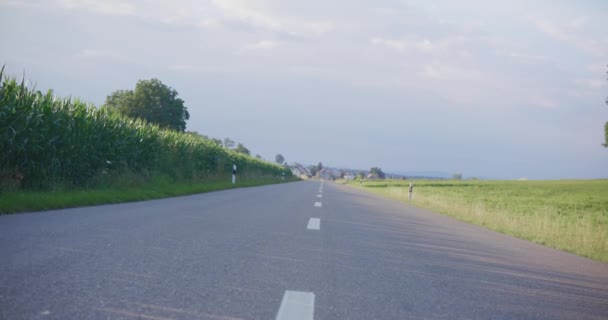 Tilted Right Angle Slow Moving European Road Large Corn Field — Stockvideo