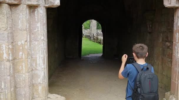 Rear View Boy Holding Camera Gimble While Filming Old Ruins — Stock video