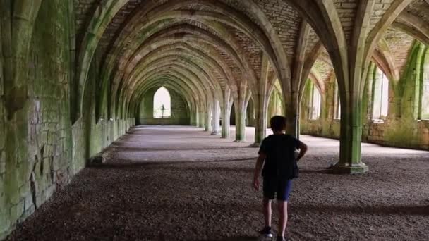 Young Boy Walking Interior Medieval Archway Supported Room Fountains Abbey — Video Stock
