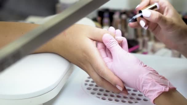 Caucasian Nail Bar Beautician Paints Female Customers Fingernails Clear — Stockvideo