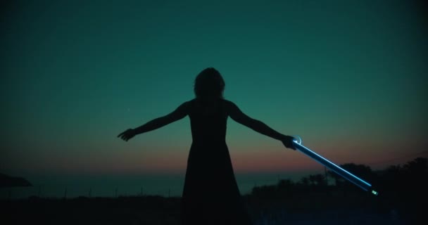 Woman Spinning Herself Dancing Holding Strip Light Neon Lighting Stick — Vídeo de Stock