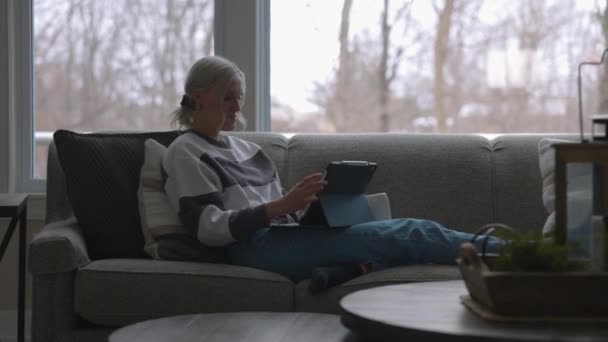 Woman Sitting Couch Front Bay Window Drinking Coffee While Scrolling — Vídeos de Stock